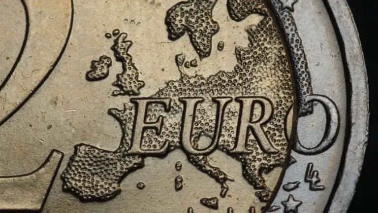 Eine Nahaufnahme einer 2-Euro-Münze auf einem Tisch, symbolisch für die deutsche Wirtschaftslage.